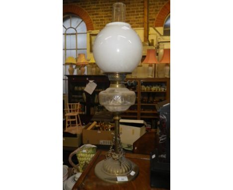 A VICTORIAN OIL LAMP with decorative brass base