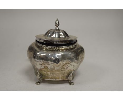 A silver tea caddy, by Elkington &amp; Co, Birmingham 1900, of bombé form with flame finial, 11cms wide, 5oz.