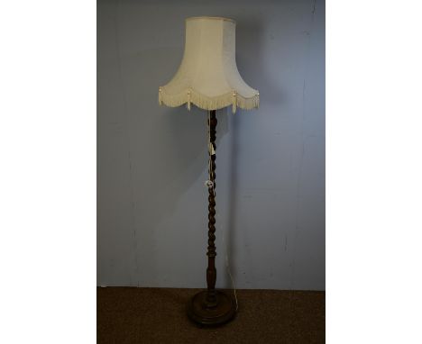 A mahogany barley-twist standard lamp, with tasseled shade, 186cms high.