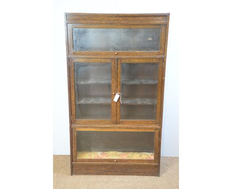 An early 20th Century oak sectional bookcase in the Globe Wernicke style., with a pair of central glazed panel doors and 'up 