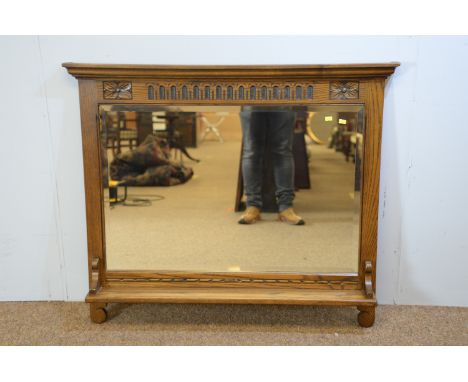 Old Charm by Wood Bros: an oak wall mirror, with carved frieze above rectangular mirror plate and shelf, 107 x 93cms.