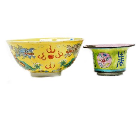 A Chinese pink enamel bowl of circular form, decorated with panels of flowers, 6cm H and a Chinese famille jaune bowl. (2)
