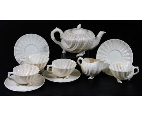 A Belleek 2nd period porcelain part Nautilus pattern tea set, comprising teapot and cover on shell feet, four cups and saucer