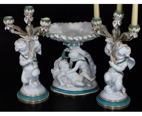 A 19thC Copeland porcelain centrepiece garniture, comprising dish of oval form held by fighting cherubs, on a naturalistic ba