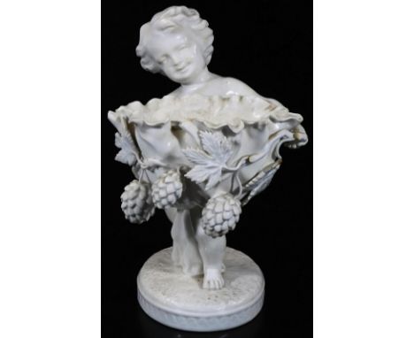 A late 19thC Copeland Spode figure, of a child holding a fruit basket, of shaped form on a naturalistic oval base, impressed 