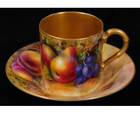 A 20thC Royal Worcester porcelain coffee can and saucer, 1924, by Harry Ayrton, handpainted with autumnal fruits, with gilt h