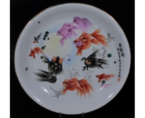 A late 20thC Chinese porcelain charger, of circular form, polychrome decorated with fish, predominately in orange and green, 