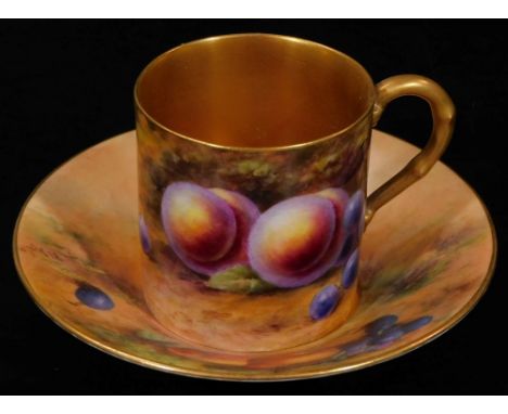 A 20thC Royal Worcester coffee can and saucer, 1923, by Ernest Barker, each decorated with autumnal fruits with gilt highligh