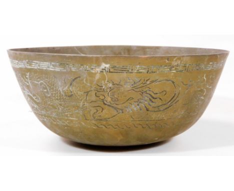 A Chinese metal bowl, profusely decorated with a banding of dragons, with an upper Greek key style border, seal mark beneath,