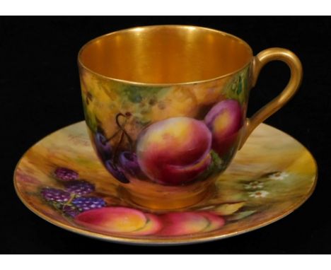 A 20thC Royal Worcester porcelain fruit pattern cup and saucer, 1921, by Harry Price, handpainted with autumnal fruits with g