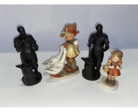 A pair of cast metal figural studies of Blacksmiths, each 20cm H and two Hummel figural studies