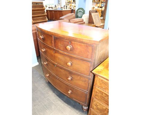A Victorian bow front chest of drawers, with two short and three long drawers, supported on turned wooden feet, 115cm W