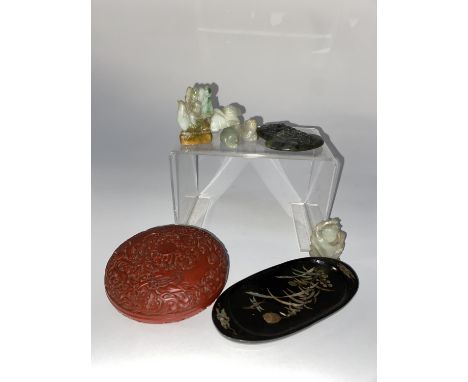 A Chinese Cinnabar lacquered lidded bowl, 10cm diameter, a Japanese black lacquered dish and a selection of Jade