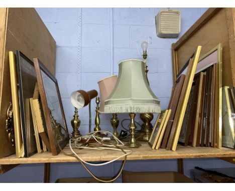 Shelf of assorted pictures, mirrors and brass lamps