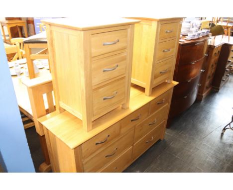 A pair of modern light oak bedside chests, a headboard and a large chest of drawers with seven drawers, 138cm W main chest, 5