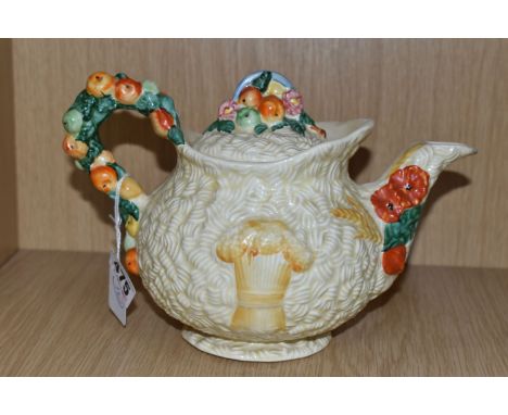 A CLARICE CLIFF 'CELTIC HARVEST' TEAPOT, moulded and painted with fruits and wheatsheaves on a textured cream ground, printed