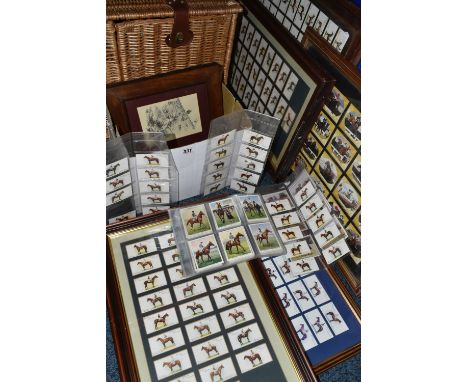 A Wicker Picnic Hamper with a few utensils, five framed sets of Cigarette Cards on a Horse Racing theme together with part se