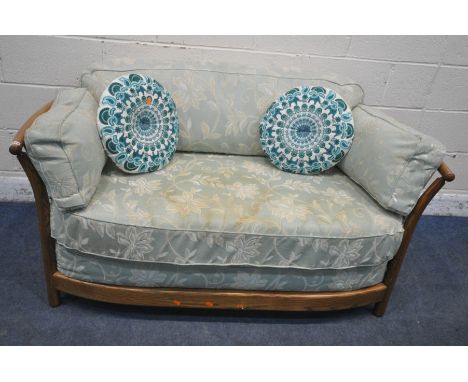 A LATE 20TH CENTURY ERCOL ASH TWO SEATER SOFA, with mint green and foliate upholstery, length 146cm x depth 79cm x height 66c