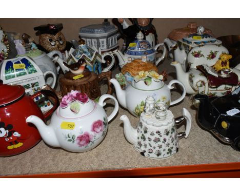 A COLLECTION OF SEVENTEEN NOVELTY CERAMIC TEA POTS, including a Price Kensington Potteries black taxi, a Cardew Old Country R