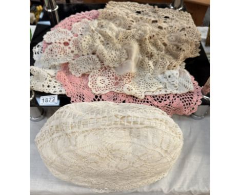 A tea cosy with lace cover &amp; a quantity of doilies