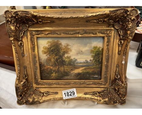 An enhanced countryside print in ormolu frame