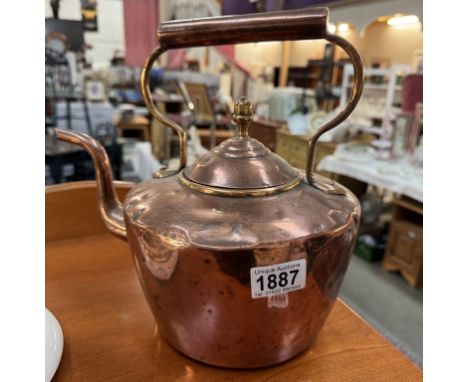 A Victorian copper kettle.