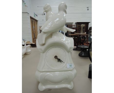 A ceramic mantle clock with dove decoration