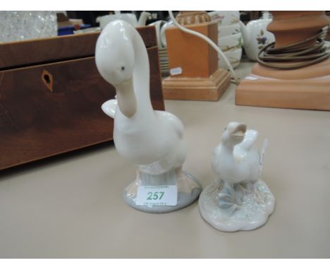 A Nao figurine, a goose and another similar