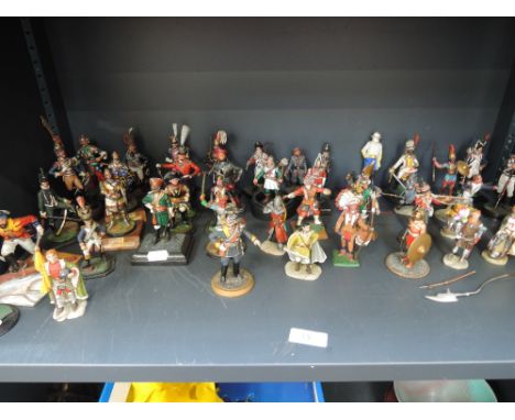 A shelf of cast models mainly military