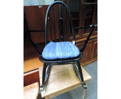 A traditional ebonised hoop and stick back rocking chair of small proportions