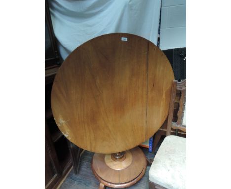 A mid Victorian light mahogany centre table having circular top on bulbous pedestal with circular platform base and triple sp