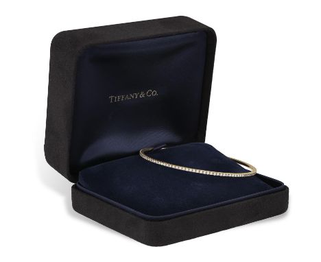 A DIAMOND 'METRO' BANGLE, BY TIFFANY & CO.Set with brilliant-cut diamonds throughout, in 18K gold, signed Tiffany & Co., Belg