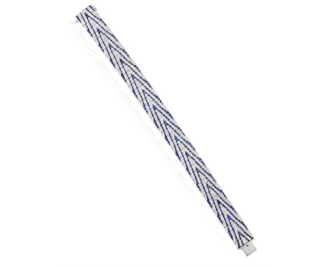 A SAPPHIRE AND DIAMOND BRACELETThe articulated strap designed in a pattern of calibré-cut sapphires, against a background pav