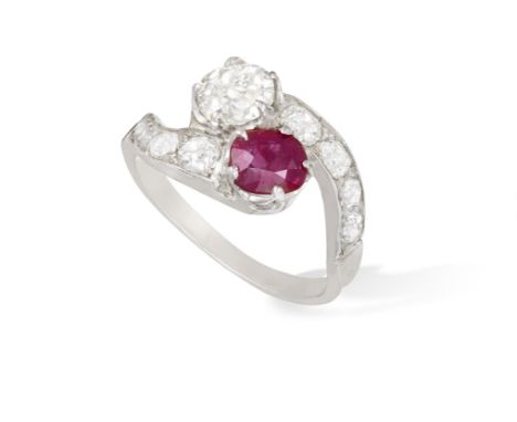 A RUBY AND DIAMOND DRESS RINGOf crossover design, set with an old cushion-shaped diamond and a cushion-shaped ruby, between s