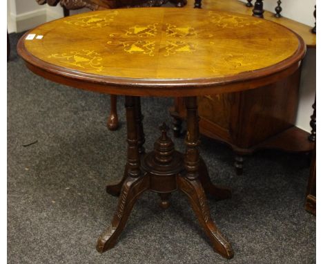 A Victorian walnut and mahogany oval breakfast table, satinwood inlaid flora above four turned supports, under finial and car