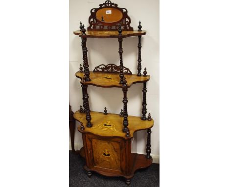 A Victorian walnut whatnot/cabinet with mirrored gallery with shaped tiers, turned supports and single door cupboard to base,