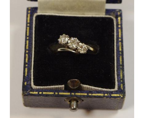 A yellow metal round diamond trilogy ring set on a twist total carat weight of approx 0.5ct, size I 1/2, 3.6g