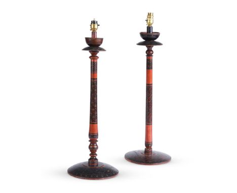 TWO INDIAN RED AND BLACK DECORATED TURNED WOOD TABLE LAMPS FIRST HALF 20TH CENTURY The tallest 64cm to the top of the wood la