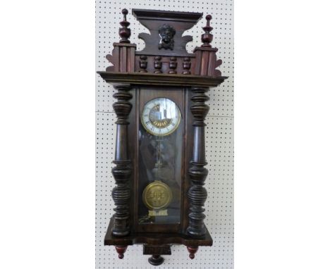 A Victorian stained birch and fruitwood Vienna style regulator, the white enamel dial with black Roman numerals, the movement