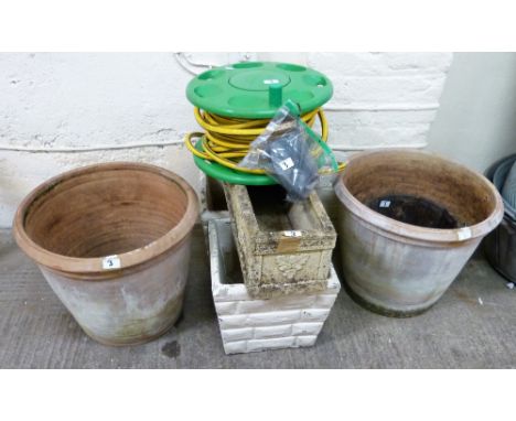 A pair of large terracotta garden urns together with a pair of composition urns, composition trough, garden hose and a brass 