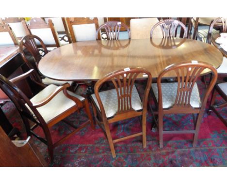 A set of five single and one carving early 20th century mahogany dining chairs in the Hepplewhite style, the carver with arch