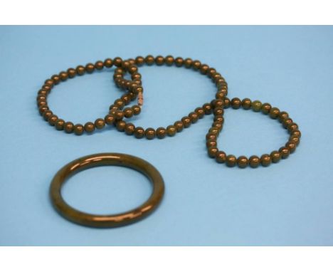 A Jade bangle and a beaded necklace.