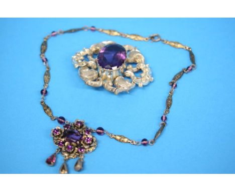An Edwardian style amethyst coloured necklace and a brooch.