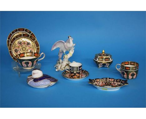 Two Royal Crown Derby tea cups, one coffee can and saucer, an oblong pin tray, a trinket box, a Duck paperweight and a Royal 