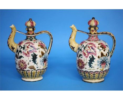 A pair of Zsolnay Pecs vases decorated with flower heads and leaves, impressed mark and printed mark, numbered 1014.  24 cm h