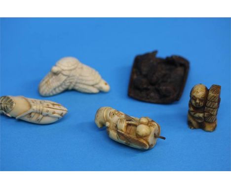 A carved wooden netsuke of turtles and four carved ivory netsukes, various. (5) 