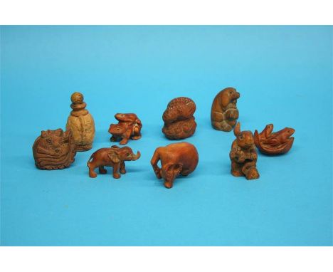 A collection of eight carved wooden animal netsuke and a small carved wooden scent bottle.