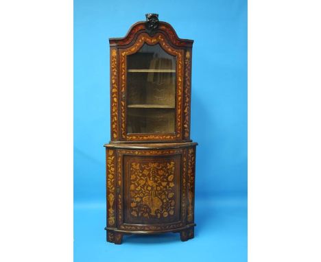  A 19th century Dutch marquetry standing corner cabinet with glazed top below a bow fronted marquetry inlaid door supported o