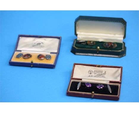 Two pairs of agate set cuff links and a pair of amethyst coloured set cuff links.