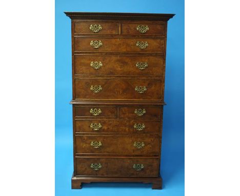 A Good quality walnut chest on chest with dentil cornice, the top section with two short and three long graduated drawers and